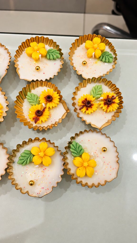 Floral diya urlis by Maelora with yellow flowers and sunflowers in gold cups