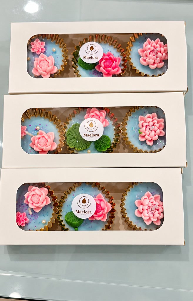 Three Maelora Lotus diya urli gift boxes, each holding a set of three