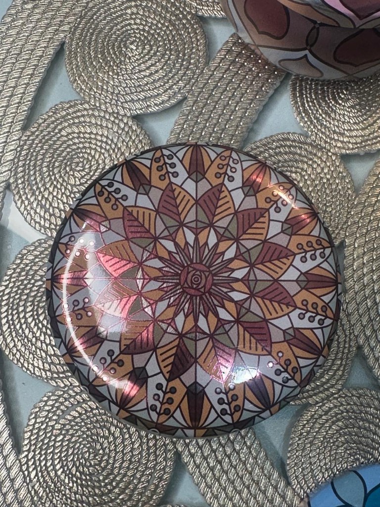 Maelora Sunset Mandala tin candle with warm orange, ochre and terracotta pattern
