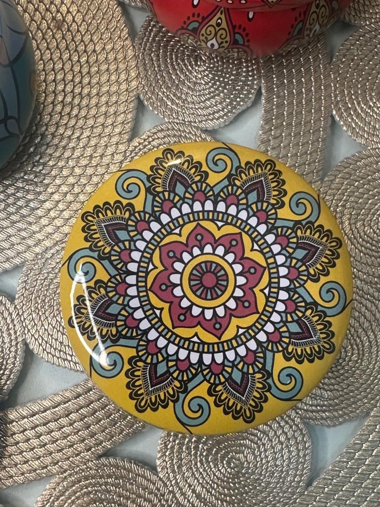 Maelora Yellow Mandala tin candle with mustard yellow and multi-coloured floral pattern