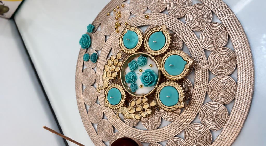 Handcrafted Peacock Garden centrepiece by Maelora — gold peacock with teal diya cups and floral wax roses